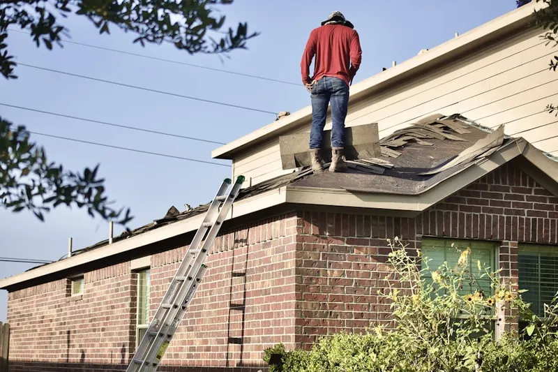Professional roofer working on a residential roof in Logan Park